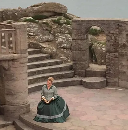 Kate onstage at The Minack Theatre in a very big frock.
