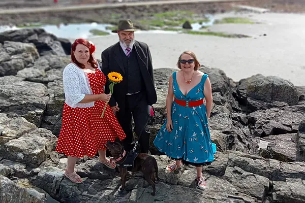 Kate and a couple standing on rocks, in 50s clothing